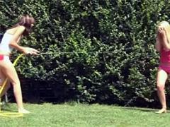 Two Cute Lesbian Chicks Playing Outside With A Water Hose